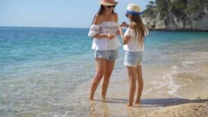 beautiful mother and daughter at caribbean beach enjoying summer vacation video