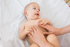 hands mother playing with baby boy cradle