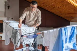 man drying clothes on a heavy duty drying rack